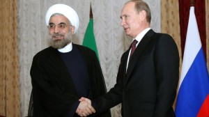 Iranian President Hassan Rouhani (left) shakes hands with Russian President Vladimir Putin at the Shanghai Cooperation Organization summit in the Kyrgyz capital of Bishkek on Sept. 13, 2013. (Photo credit: Press TV)